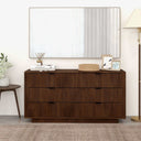 Wooden dresser with decorative items in a room setting