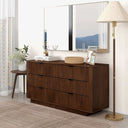 Wooden dresser with decorative items in a room setting
