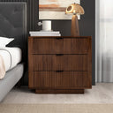 Wooden nightstand with two drawers next to a bed in a bedroom setting.