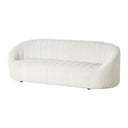 A three-quarters view of an off-white sofa with quilted design on a white background