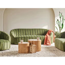 Olive-Green sofa with wooden coffee tables and decorative items in a modern living room.