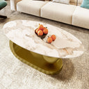 Marble coffee table with a gold base in a living room setting.