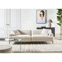 Contemporary living room with a light beige sofa, glass coffee table, and decorative elements.