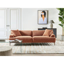 Golden-brown sectional sofa in a modern living room with a glass coffee table and decorative elements.