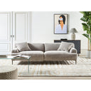Contemporary living room with a light grey sofa, glass coffee table, and decorative elements.