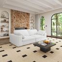 Modern living room with a white loveseat, coffee table, and decorative elements.