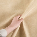 Hand touching beige fabric