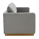 Side view of a gray sofa with a gold base on a white background.