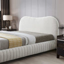 Modern bedroom with a textured bed and matching headboard.