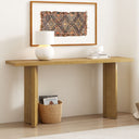 Wooden console table with decorative items against a plain wall