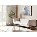 Modern living room with an off-white sofa, coffee table, and abstract painting.