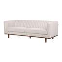 Three-quarters view of a Skaule mid-century modern sofa in an off-white textured fabric, with vertical channel stitching on the back and inner arms, two seat cushions with piping, and a dark wood base with tapered legs.