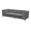 Three-quarters view of a Sotra contemporary sofa in grey velvet, featuring all-over diamond button tufting on the low back and arms, two smooth seat cushions, and sleek, angled chrome legs.