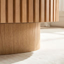 Close-up of a wooden cabinet with a ribbed design on a light background