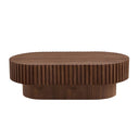 Front view of a walnut oval wooden coffee table with ribbed surface on a white background.