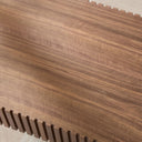 Close-up of a walnut wooden coffee table top with a visible grain pattern.