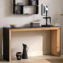 Wooden console table with decorative items against a neutral wall.