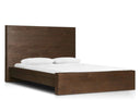 A brown Torrington bed with a high-rise headboard, made of resawn umber oak, with a mattress and white bedding.