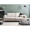 Modern living room with a light beige sofa, coffee table, and decorative items.