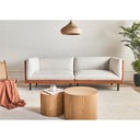 Modern living room with an off-white sofa, wooden coffee table, and decorative items.