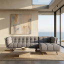 Adele 103-inch ash grey fabric right-facing sectional sofa with grid tufting and tapered wooden legs in a modern living room with ocean views.