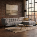 Adele 103-inch ash grey fabric right-facing sectional sofa with grid-tufted upholstery in a modern living room with an exposed brick wall and round glass coffee table.