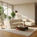 Adele 103-inch cream bouclé right-facing sectional sofa with channel tufting in a modern sunlit living room with a low wood coffee table, arched floor lamp, and large windows.
