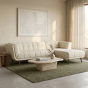 Adele 103-inch cream bouclé right-facing sectional sofa with channel tufting styled in a minimalist living room on an olive green area rug with a travertine coffee table.