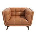Front view of the Adele cognac leather accent armchair, featuring grid-tufted cushioning with button details on the backrest, wide rounded arms, a deep cushioned seat, and tapered dark wood legs against a solid white background.