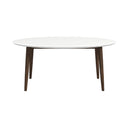 Mid-century modern oval dining table featuring a smooth white tabletop and tapered dark wood legs on a plain white background.
