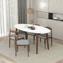 Modern 67-inch oval dining table with a white top and tapered dark wood legs, surrounded by four matching chairs with gray upholstered seats on a textured area rug.
