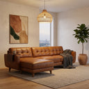 Adriana 111-inch tan genuine leather left-facing chaise sectional sofa featuring tufted cushions and a built-in wooden armrest tray in a warm, modern living room.