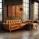Adriana 111-inch tan genuine leather right-facing sectional sofa with button-tufted backrest cushions and tapered wooden legs styled in an industrial loft living room featuring an exposed brick wall, brass arc floor lamp, and large grid windows.