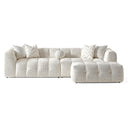 Agnes 113-inch ivory tufted chenille modular sofa with a matching modular ottoman, featuring low-profile channel-tufted seats, textured cream upholstery, chevron-patterned throw pillows, and a round accent pillow, isolated on a white background.