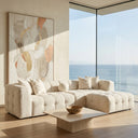 Agnes 113-inch ivory tufted chenille modular sectional sofa with chaise and accent pillows in a modern ocean-view living room