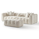 Agnes 113-inch ivory tufted chenille modular sofa with a matching modular ottoman, featuring low-profile channel-tufted seats, textured cream upholstery, chevron-patterned throw pillows, and a round accent pillow, isolated on a white background.