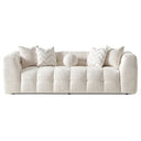 Modern Agnes 90-inch tufted ivory chenille sofa featuring a block-tufted seat, styled with matching chevron and solid throw pillows and a central round sphere pillow, set against a white background.
