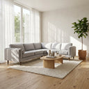 Allegra 105 light grey fabric sectional corner sofa with wooden legs set in a bright modern living room with an oval wooden coffee table and textured cream area rug.