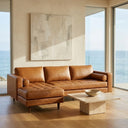 Anita 102-inch tan genuine top-grain leather left-facing sectional sofa with tufted seat cushions and bolster pillows in a modern ocean-view living room