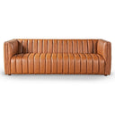 April 86-inch cognac genuine leather sofa featuring vertical channel tufting and a modern tuxedo silhouette on a white background