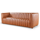 April 86-inch cognac brown genuine leather sofa featuring vertical channel tufting along the seat, backrest, and shelter arms on a white background.