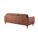 Rear three-quarter view of the Armando sofa, showcasing the smooth leather back panel, the profile of the arm, and its four dark tapered legs.