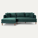 Bayley 107-inch dark green velvet left-facing sectional sofa with tapered wooden legs and matching accent pillows on a white background.