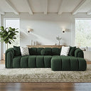  Bella 114-inch dark green French bouclé right-facing sectional sofa featuring vertical channel tufting and curved arms, styled with accent pillows on an ornate rug in a bright, contemporary living room.