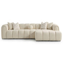 Bella 114-inch ivory tufted bouclé right-facing sectional sofa featuring vertical channel cushioning, rounded armrests, matching chevron throw pillows, and a right-side chaise lounge against a white studio background.