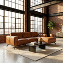 Berry 102-inch cognac vegan eco-leather right-facing sectional sofa with right chaise styled in a sunlit modern industrial loft featuring exposed brick walls and large grid windows.