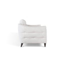 A side profile view of the Bianca contemporary sofa, showcasing the white leather upholstery, horizontal channel-tufting on the side panel, and the gentle curve of its backrest.