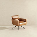 Camila tan genuine leather swivel chair featuring a low-profile cushioned backrest, deep comfortable seat, and sloped armrests, supported by a modern four-star black metal swivel base on a neutral textured background.