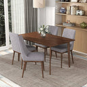 Walnut rectangular dining table surrounded by four grey upholstered chairs on a textured rug, featuring a floral centerpiece in a modern dining room.

