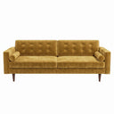 Casey mid-century modern gold velvet upholstered sofa featuring a button-tufted back, matching cylindrical bolster pillows, and tapered dark wood legs on a white background.